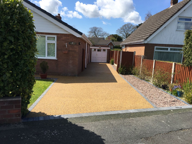 Golden resin bound driveway with charcoal block edging
